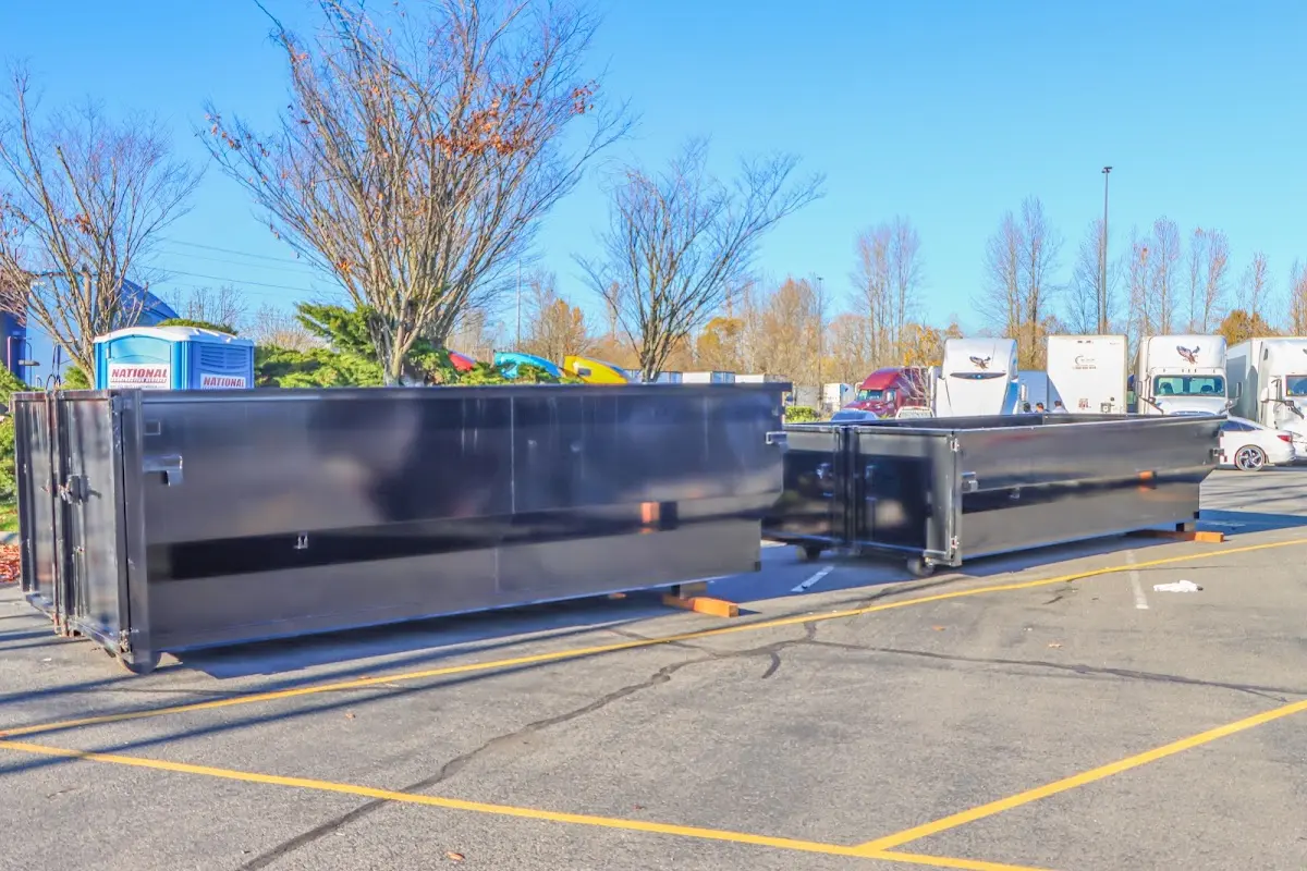 Professional dumpster rental service with roll-off container on residential driveway in Jasmine Estates